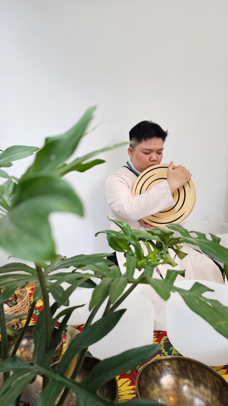 Kennedy Khánh Nguyễn playing an ocean drum among singing bowls